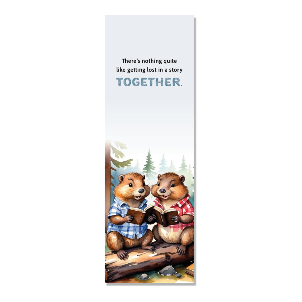 A book marker featuring illustrations of two beavers sitting on a log, with one beaver holding a book and the other beaver reading. The background is a forest.